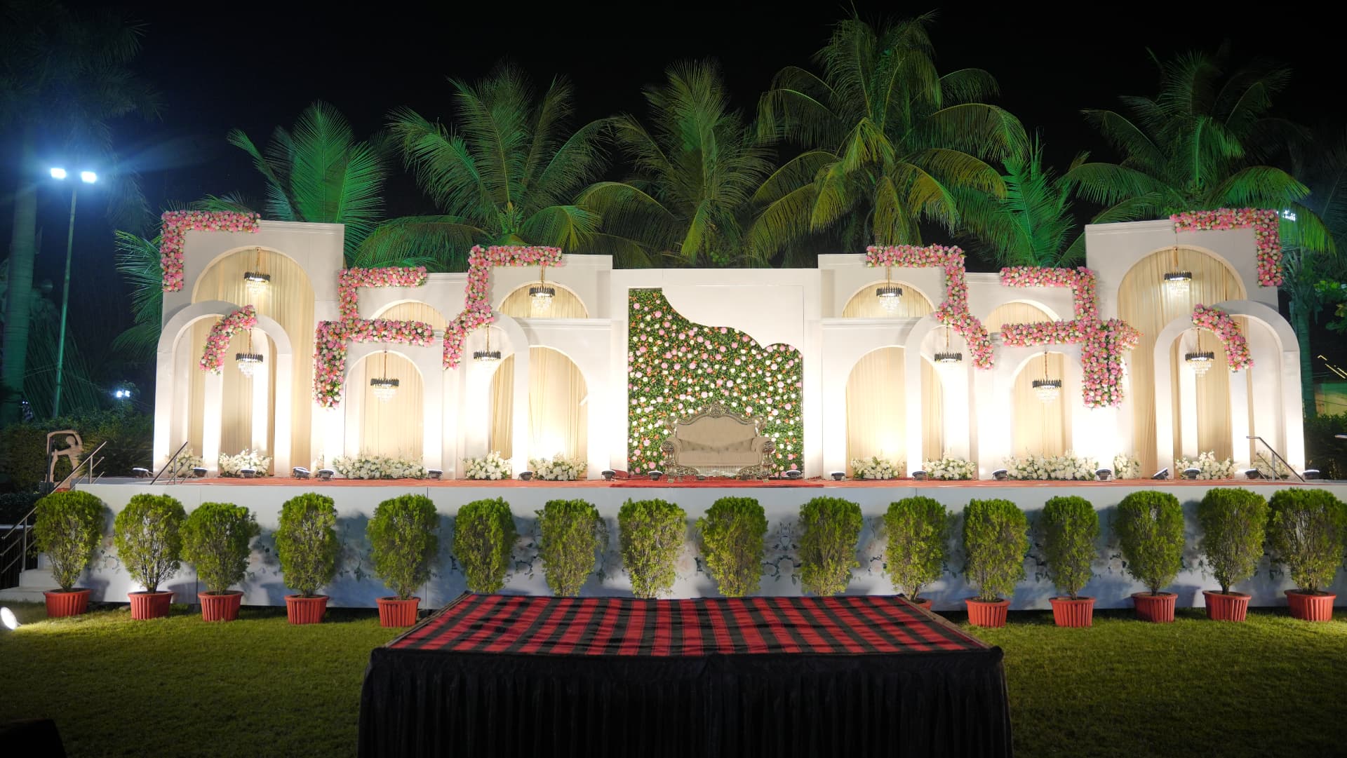 Reception stage lit up at night at Hari Amrit
